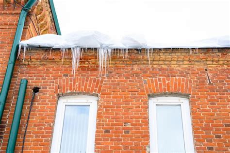 Premium Photo | Big icicles above the entrance to a residential ...