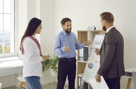 Team Of Three People Meeting In The Office And Discussing Their