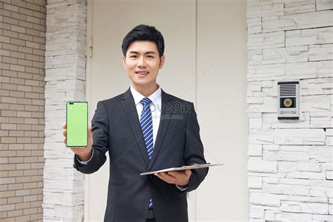 Male Real Estate Sales Staff Show Mobile Phone Picture And Hd Photos