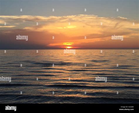 Pretty beach photo at sunset Stock Photo - Alamy