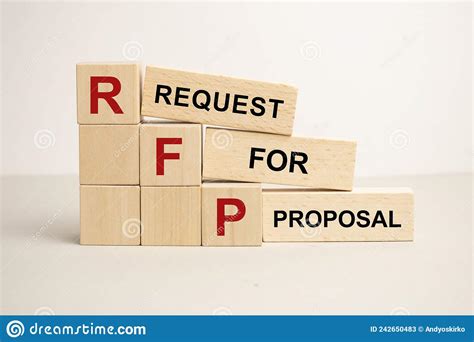 Three Wooden Cubes With The Letters Rfp On The Bright Surface Of A Gray