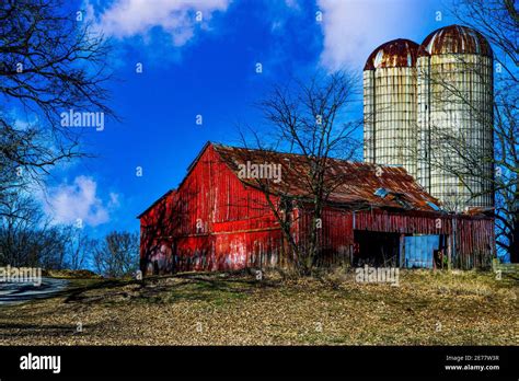 Old Red Barn With Silo Towering Above Stock Photo Alamy