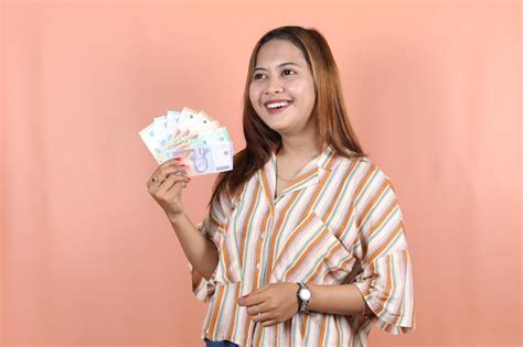 Premium Photo Holding Cash Money In Indonesian Rupiah