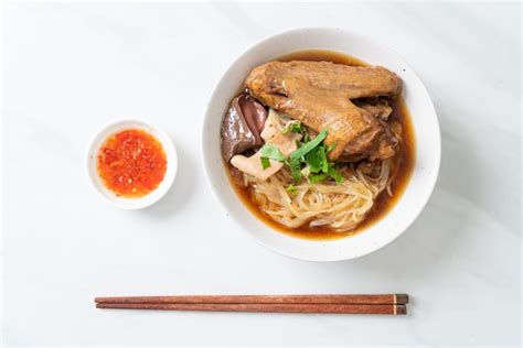 Premium Photo Braised Duck Noodles With Brown Soup