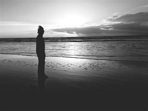 Premium Photo Silhouette Person Standing On Shore At Beach Against Sky