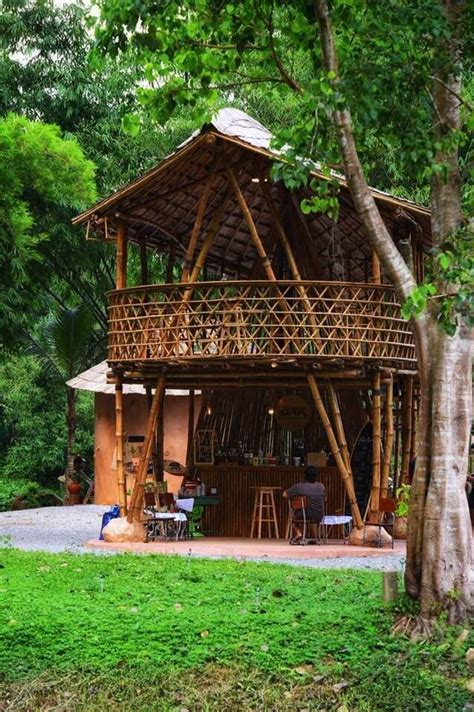 A Wooden Structure Sitting In The Middle Of A Lush Green Field Next To