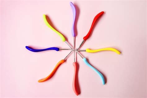 Premium Photo Colorful Hooks Of Different Sizes In Form Of Circle On Pink Background Top View