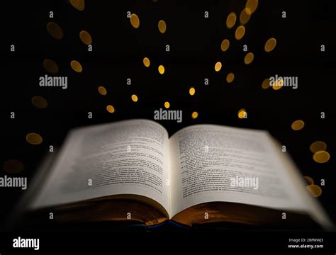 A Book With Gold Edges Is Highlighted With Glowing Star Lights In The