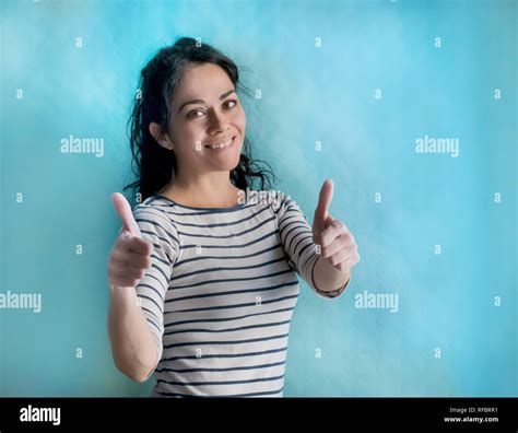 Brunette Woman Over Isolated Background Doing Happy Thumbs Up Gesture