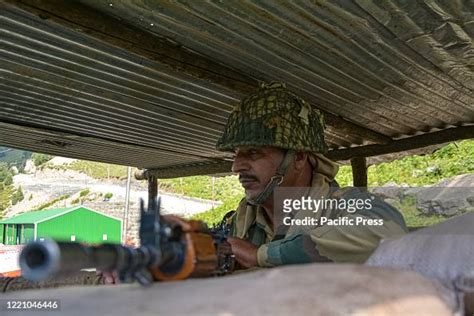 Border Security Force personnel keeps vigil at a checkpoint along a ...