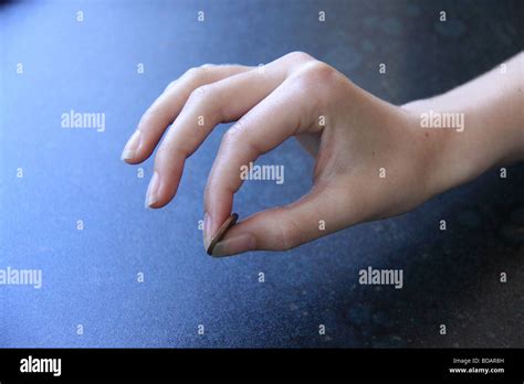 Hand Holding Coin Between Thumb And Forefinger Stock Photo Alamy