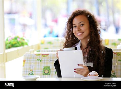 Beautiful Business Woman With White Tablet In The Restaurant Stock