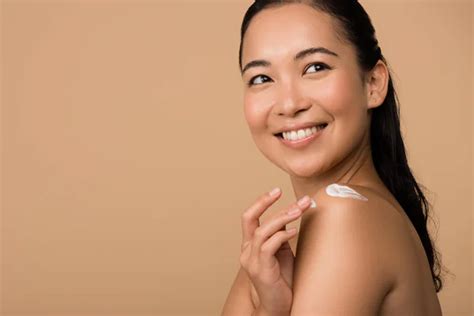 Smiling Beautiful Naked Asian Girl Holding Eyelash Curlers Isolated