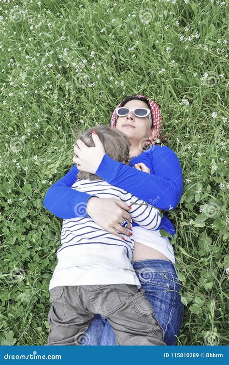 Mother And Her Son Lying On Grass In Spring Stock Image Image Of