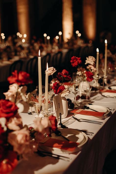 A Long Table Is Set With Candles And Flowers For A Formal Dinner Or