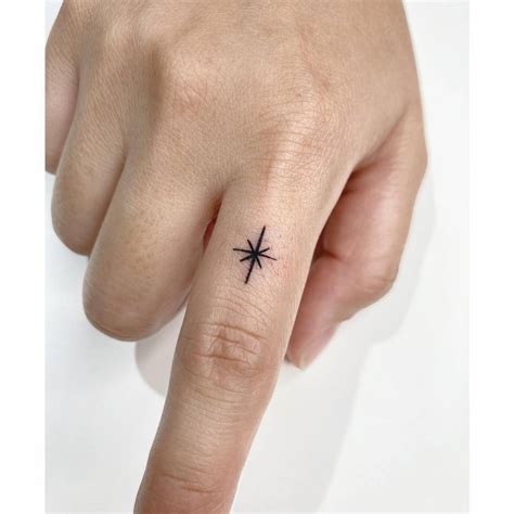 Small North Star Tattoo Located On The Finger