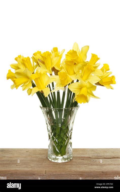 Bunch Of Daffodils In A Cut Glass Vase On A Wooden Shelf Against A