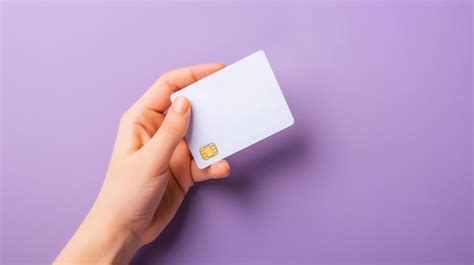 A Hand Holding A Blank White Credit Card Against A Purple Background