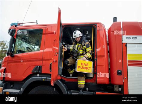 Firefighter Leaving Fire Engine Stock Photo Alamy