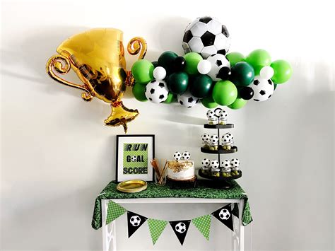 A Soccer Themed Party With Balloons And Decorations