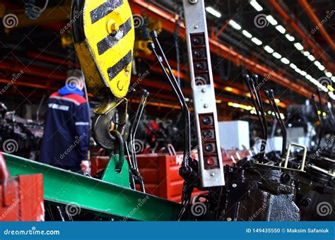 Bridge Lifting Crane Hook Against The Background Of The Assembly Line