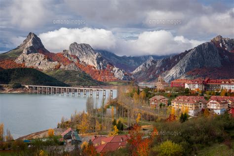 Riano Cityscape At Sunrise With Mountain Range Landscape During Autumn