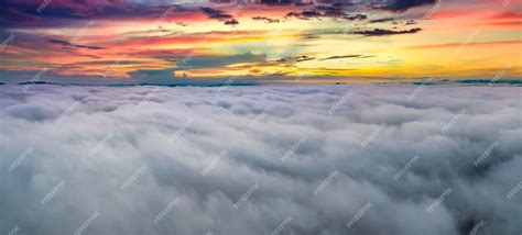 Premium Photo | Aerial view of colorful sunrise over white dense fog ...