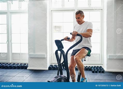 Fit Mature Man Exercising On A Health Club Stationary Bike Stock Image Image Of Cross