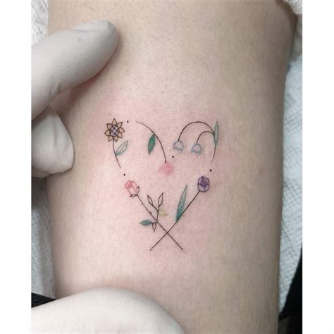 Flower Heart Tattoo Located On The Upper Arm