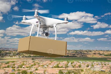 Unmanned Aircraft System UAS Quadcopter Drone Carrying Blank Package Over Neighborhood 16362899