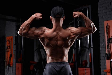 Premium Photo Handsome Strong Athletic Man Pumping Up Muscles