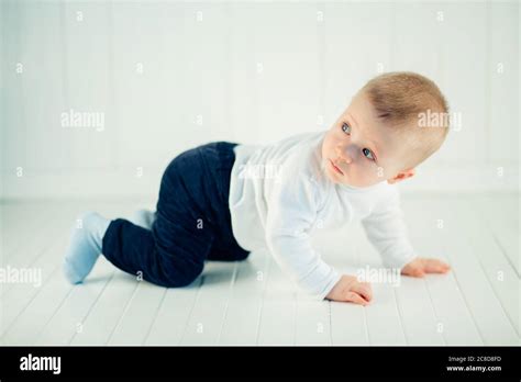 Side View Of Pretty Crawling Baby On Bed Stock Photo Alamy