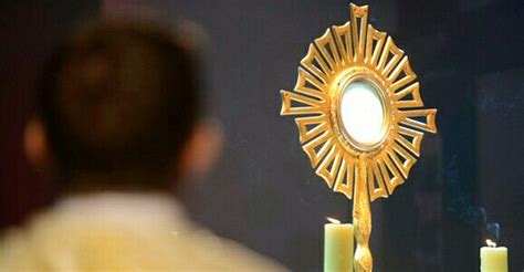 A Man Looking At A Mirror With Candles In Front Of It And A Candle Holder