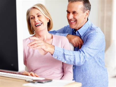 Premium Photo Cheerful Mature Man With Wife Pointing At Computer
