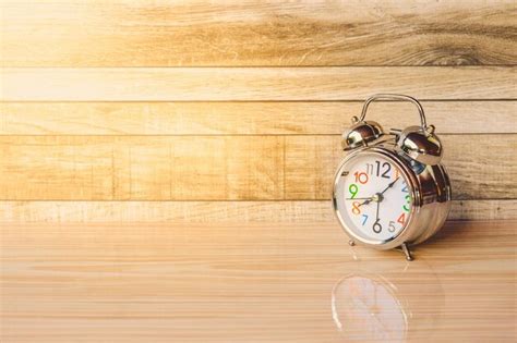 Premium Photo Alarm Clock On Wooden Table