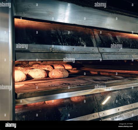 Oven In The Bakery Hot Fresh Bread Leaves The Industrial Oven In A Bakery Stock Photo Alamy