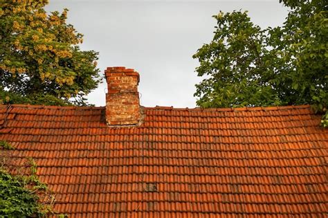 Красная черепичная крыша с дымовой трубой из красного кирпича, крыша ...