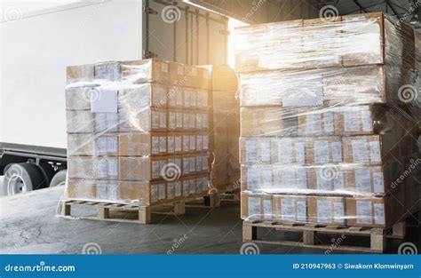 Stacked Of Package Boxes Wrapping Plastic On Pallet Waiting To Load