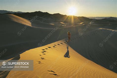 Naked Female Walking In The Sand Dunes Superstock