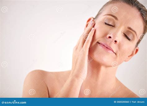 So Soft Cropped Studio Shot Of An Attractive Mature Woman Touching
