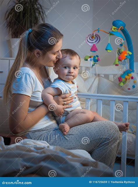 Cute 9 Months Old Baby Boy Sitting On Mother Lap Before Going To Bed