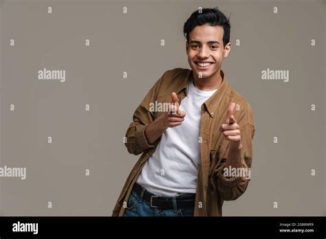 Brunette Hispanic Man In Shirt Smiling And Pointing Fingers At Camera