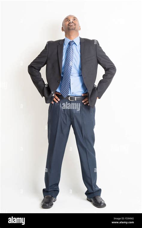 Full Body Mature Indian Business Man Hand On Waist And Looking Up