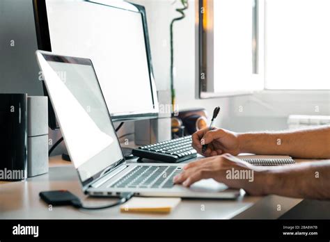 Person working from home at their desk with computers Stock Photo - Alamy