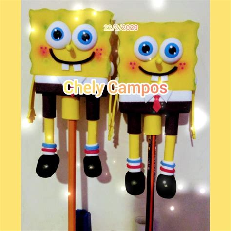 Two Yellow Spongebobs With Blue Eyes Are Standing Next To Each Other