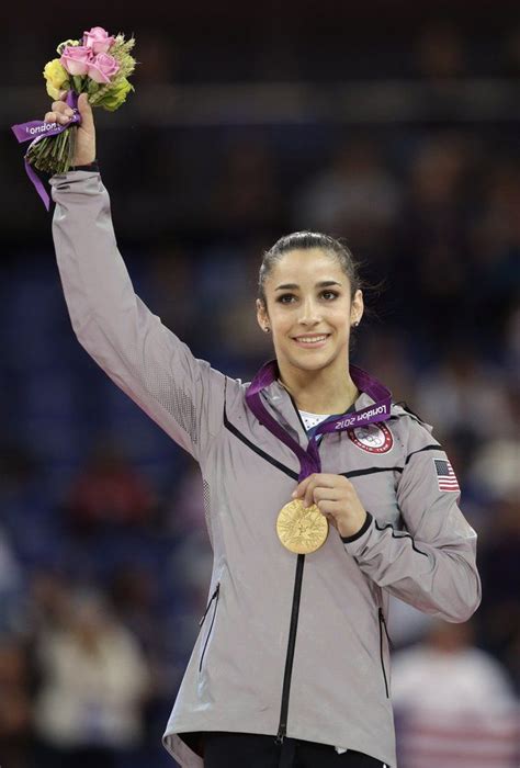 U S Gymnast Aly Raisman Displays Her Gold Medal During The Podium Ceremony For The Artistic