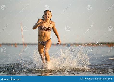 Water Fun The Girl Runs Along The Seashore Stock Photo Image Of