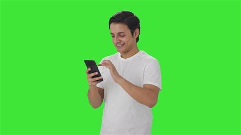 Happy Indian Man Scrolling Through Phone Green Screen People Stock