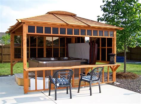 An Outdoor Hot Tub With Chairs And Table Next To It In Front Of A