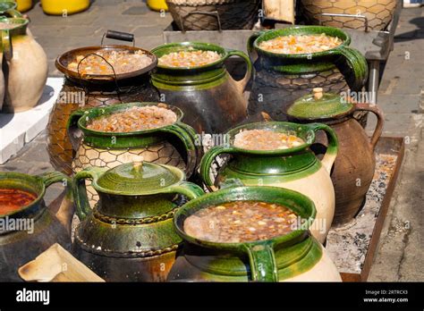 Hungarian Goulash Cooked In Green Brown Clay Pots By An Outdoor Fire